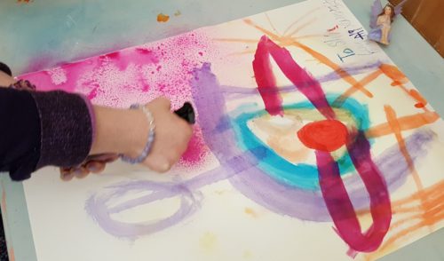 Someone spraying Ink onto a watercolour design on paper Someone spraying Ink onto a watercolour design on paper
